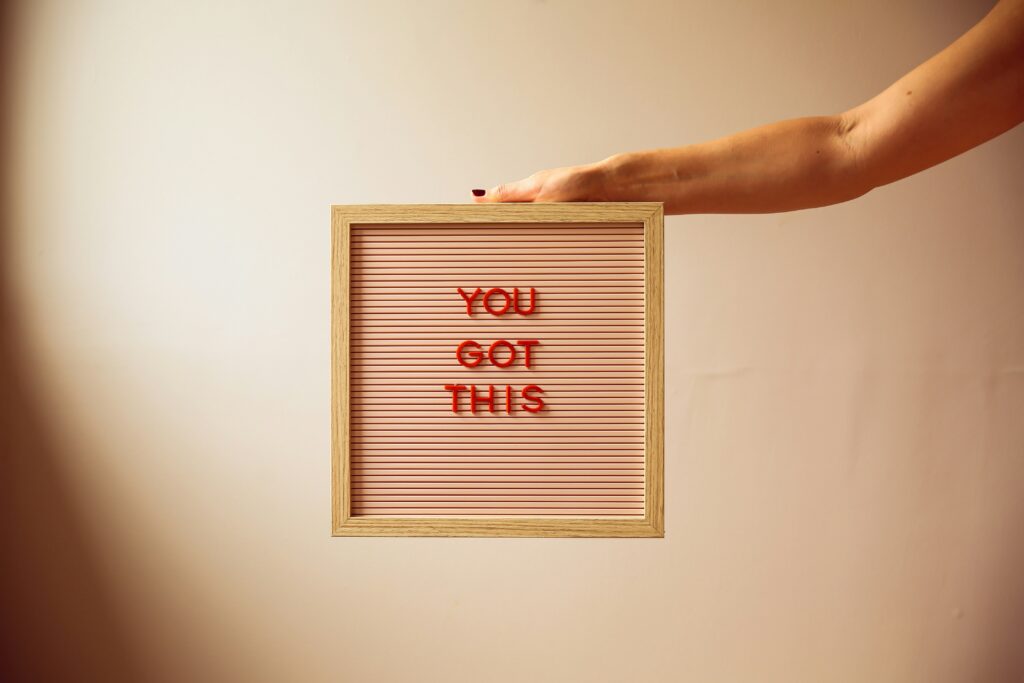 Frame with "you got this" written in it held by someone. 